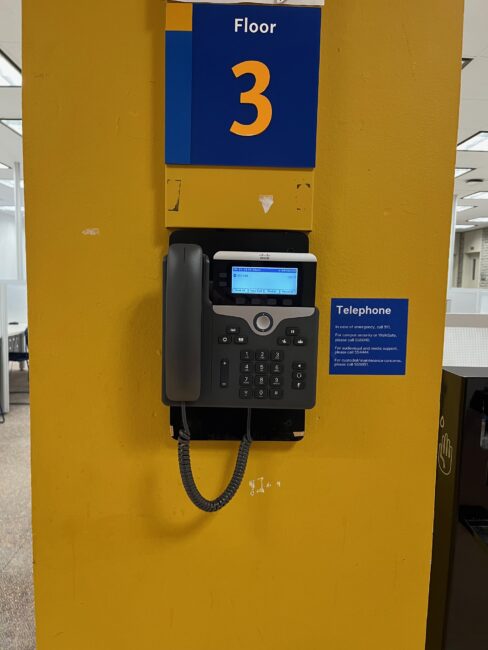 Phone mounted on pillar in front of elevators
