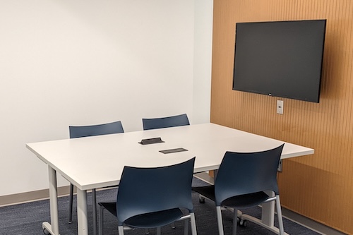 Private study room with a table with chairs and large screen
